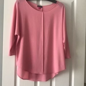 Carnation pink blouse with dolman sleeves.